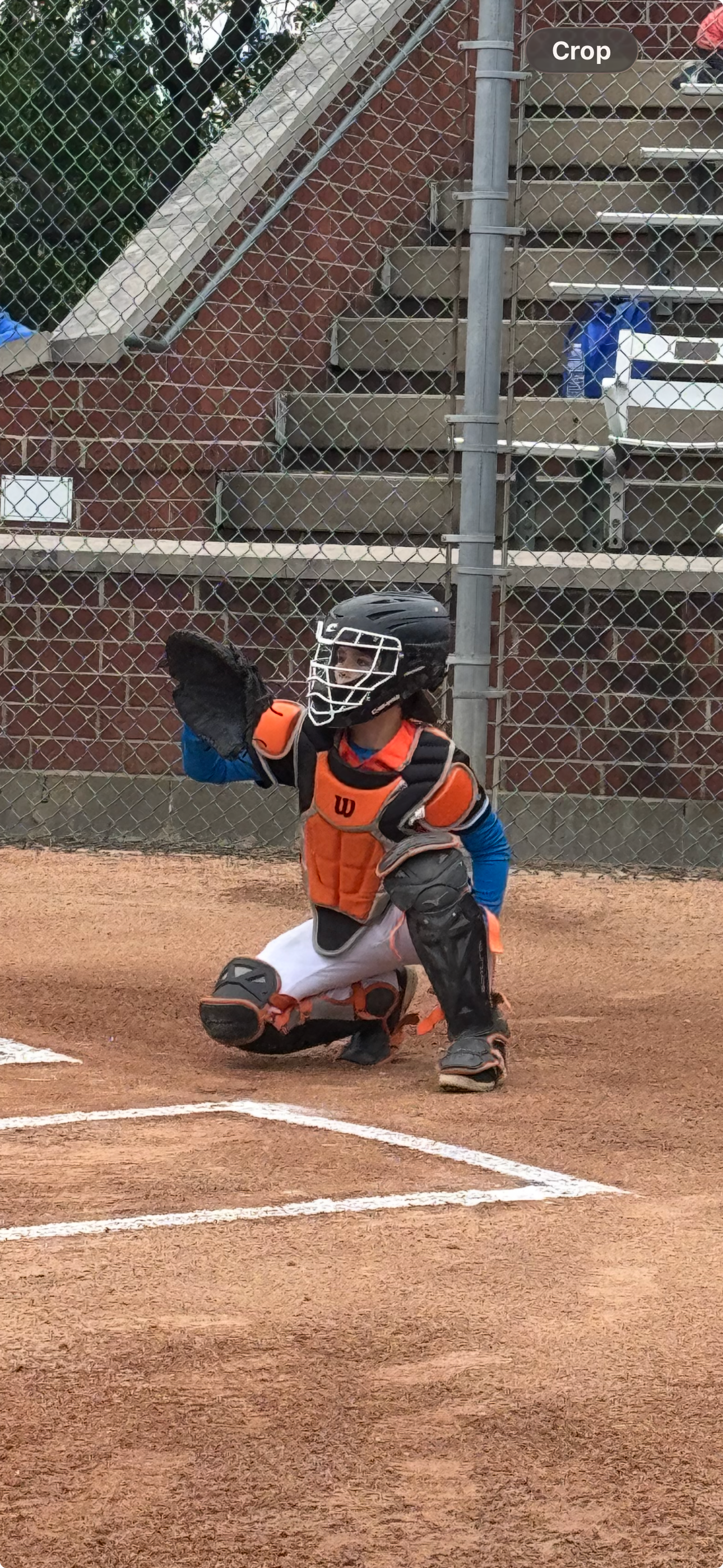 Youth baseball catcher ready to receive at home plate